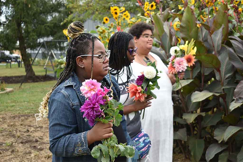 Easterseals Arc clients picking flowers